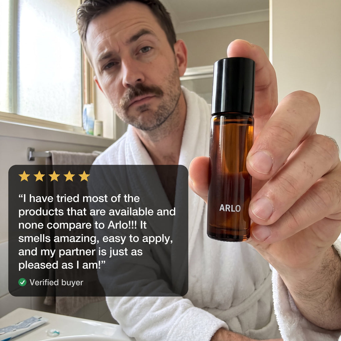 A verified buyer holding the ARLO roll-on with his review