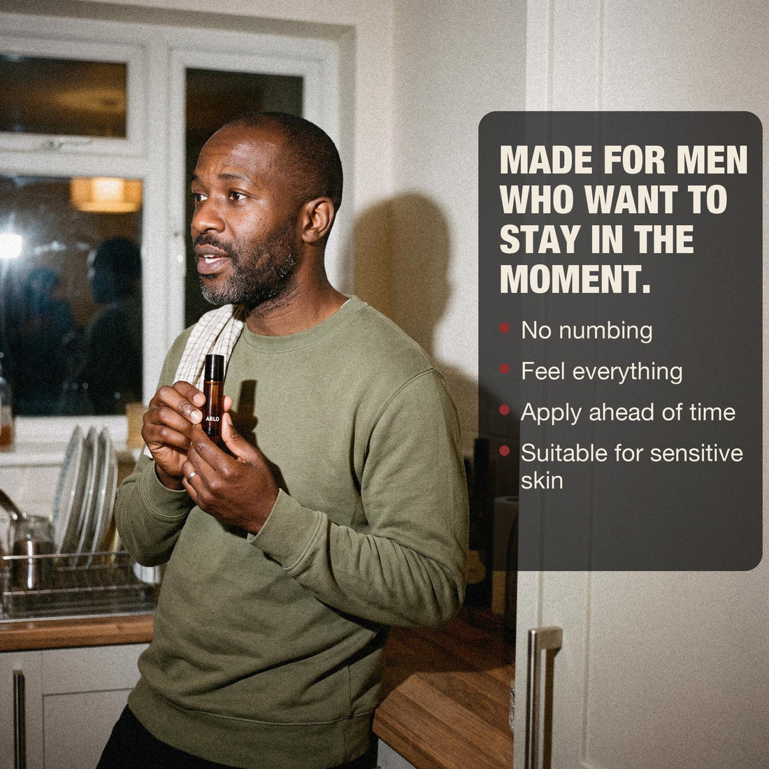 A man in his kitchen holding ARLO
